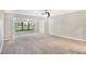 Spacious bedroom with plush carpeting and large windows at 7301 Ballantrae Pl # 27D, Sarasota, FL 34238