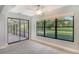 Bedroom with sliding glass doors to a screened patio at 7301 Ballantrae Pl # 27D, Sarasota, FL 34238
