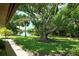Serene backyard oasis with lush landscaping, large tree, and peaceful waterway view at 7301 Ballantrae Pl # 27D, Sarasota, FL 34238