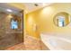 Bathroom with glass shower and soaking tub at 1711 Hudson St, Englewood, FL 34223