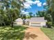 House exterior showcasing a stone facade and lush greenery at 1711 Hudson St, Englewood, FL 34223