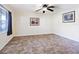 Bright living room featuring tile floors and ceiling fan at 4805 Rilma Ave # 104, Sarasota, FL 34234