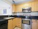 Kitchen boasts stainless steel appliances and ample wood cabinets at 4805 Rilma Ave # 104, Sarasota, FL 34234