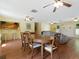 Bright dining room with hardwood floors and wood table at 4805 Rilma Ave # 104, Sarasota, FL 34234