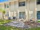 Private backyard patio with two lounge chairs and small lawn at 4805 Rilma Ave # 104, Sarasota, FL 34234