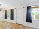 Dining room with tile floors and white door at 4805 Rilma Ave # 104, Sarasota, FL 34234