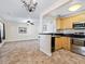 Open dining area with view into kitchen and living room at 4805 Rilma Ave # 104, Sarasota, FL 34234