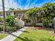 Condo building exterior with lush landscaping and walkway at 4805 Rilma Ave # 104, Sarasota, FL 34234