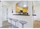 Kitchen with light wood cabinets, stainless steel appliances, and a breakfast bar at 4805 Rilma Ave # 104, Sarasota, FL 34234