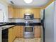 Well-equipped kitchen featuring stainless steel appliances and light wood cabinets at 4805 Rilma Ave # 104, Sarasota, FL 34234