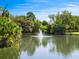 Serene pond with a water fountain and lush greenery at 4805 Rilma Ave # 104, Sarasota, FL 34234