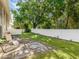 Private backyard with grassy area, patio, and mature trees at 4805 Rilma Ave # 104, Sarasota, FL 34234