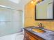 Bathroom featuring a walk-in shower and dark vanity at 4805 Rilma Ave # 104, Sarasota, FL 34234