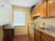 Small kitchen with wood cabinets, microwave, and stove at 4805 Rilma Ave # 104, Sarasota, FL 34234