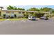 Exterior view of a light yellow condominium building with parking at 4805 Rilma Ave # 104, Sarasota, FL 34234