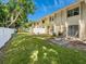 Spacious backyard with grassy area, patio, and white fence at 4805 Rilma Ave # 104, Sarasota, FL 34234