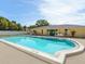 Community swimming pool with surrounding patio at 4805 Rilma Ave # 104, Sarasota, FL 34234