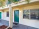 Condo building exterior showcasing a teal door and window at 4805 Rilma Ave # 104, Sarasota, FL 34234