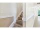 Indoor staircase with beige tile and white trim at 4800 Rilma Ave # 143, Sarasota, FL 34234