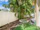 Small patio with table and chairs, surrounded by palm trees at 4800 Rilma Ave # 143, Sarasota, FL 34234