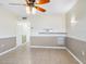 Bright living room with tile floors, ceiling fan, and neutral walls at 4800 Rilma Ave # 143, Sarasota, FL 34234