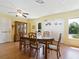 Dining room with oval wooden table and six chairs at 4800 Rilma Ave # 143, Sarasota, FL 34234