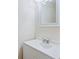 Small bathroom with white vanity and a framed mirror at 4800 Rilma Ave # 143, Sarasota, FL 34234