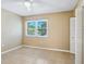 Bedroom with ceiling fan, large window, and closet at 4800 Rilma Ave # 143, Sarasota, FL 34234