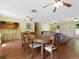 Bright dining room with hardwood floors and large table at 4800 Rilma Ave # 143, Sarasota, FL 34234