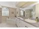 Elegant bathroom with double vanity, large mirror, and a corner jacuzzi tub at 139 Long Meadow Lane Ln, Rotonda West, FL 33947