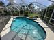 Inviting kidney-shaped pool with a spa and screened enclosure at 139 Long Meadow Lane Ln, Rotonda West, FL 33947
