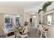 Bright dining room with glass-top table, wicker chairs and access to a patio at 139 Long Meadow Lane Ln, Rotonda West, FL 33947