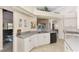 Open kitchen with white cabinets, breakfast bar, and view of the living room at 139 Long Meadow Lane Ln, Rotonda West, FL 33947