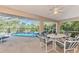 Screened patio with pool view and seating area for dining at 139 Long Meadow Lane Ln, Rotonda West, FL 33947
