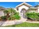 Welcoming front entry with lush landscaping at 139 Long Meadow Lane Ln, Rotonda West, FL 33947