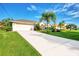 Long driveway leading to a two-car garage at 139 Long Meadow Lane Ln, Rotonda West, FL 33947