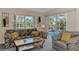 Bright Gathering room with pool view, comfy seating, and sliding glass doors at 139 Long Meadow Lane Ln, Rotonda West, FL 33947
