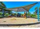 Community playground with shaded play structures at 139 Long Meadow Lane Ln, Rotonda West, FL 33947