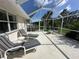 Relaxing screened patio with lounge chairs and a view of the yard at 139 Long Meadow Lane Ln, Rotonda West, FL 33947