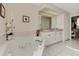 Spa-like bathroom with double vanity, large mirror and a jacuzzi tub at 139 Long Meadow Lane Ln, Rotonda West, FL 33947