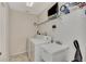 Laundry room with washer, dryer, utility sink, and shelving at 139 Long Meadow Lane Ln, Rotonda West, FL 33947