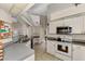 Efficient kitchen featuring white cabinetry, stainless steel appliances, and a breakfast bar at 139 Long Meadow Lane Ln, Rotonda West, FL 33947