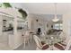 Open dining area with glass-top table, wicker chairs and kitchen views at 139 Long Meadow Lane Ln, Rotonda West, FL 33947
