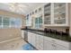 White kitchen with granite countertops and glass-front cabinets at 839 40Th St, Sarasota, FL 34234