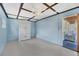 Bedroom with white armoire and adjacent room with white wicker bed and blue accents at 839 40Th St, Sarasota, FL 34234