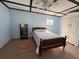 Bright bedroom with a paneled ceiling, ceiling fan, wood-framed bed, wardrobe and small window at 839 40Th St, Sarasota, FL 34234