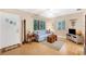 Living room with a blue couch, hardwood floors, and a ceiling fan at 839 40Th St, Sarasota, FL 34234