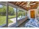 Bright screened porch with backyard view and comfy seating at 839 40Th St, Sarasota, FL 34234