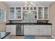 Kitchen with white cabinets, granite countertops, and glass-front upper cabinets at 839 40Th St, Sarasota, FL 34234