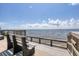 Relaxing waterfront view from a wooden deck with benches at 839 40Th St, Sarasota, FL 34234